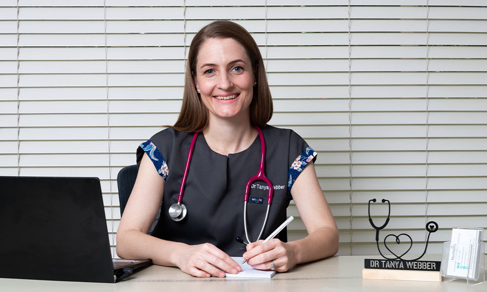 Dr Tanya Webber sitting behind a desk