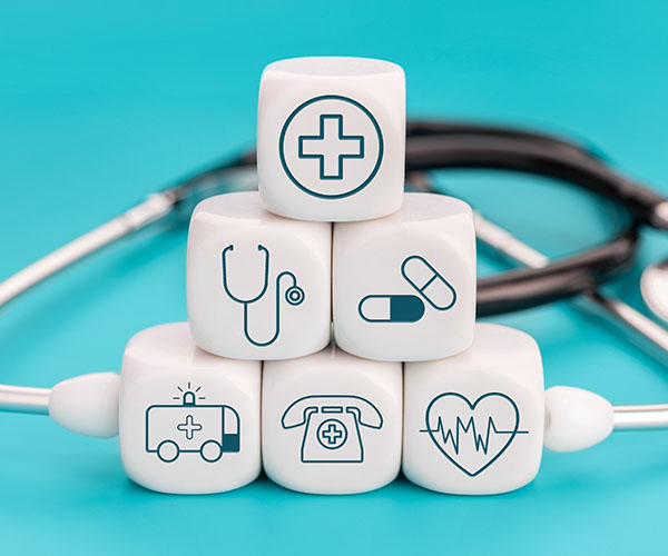 White cubes with various General practitioner icons and stethoscope in background